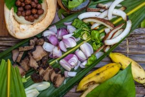 Tuna, onion, chili, coconut, and banana on banana leaves