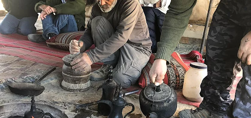 A traditional Bedouin tourism in israel experience involving brewing tea along a community trali