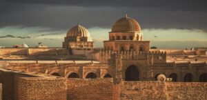 Rooftop view of Mosque Okba (Great Mosque of Kairouan) in Kairoan, Tunisia during the enchanting golden hour of late afternoon.