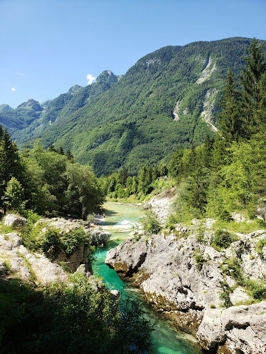 picture of the bright turquoise Soca River in the Julian Alps. Showcasing the natural beauty of Slovenia. Photo by Author, Stephanie Gerson