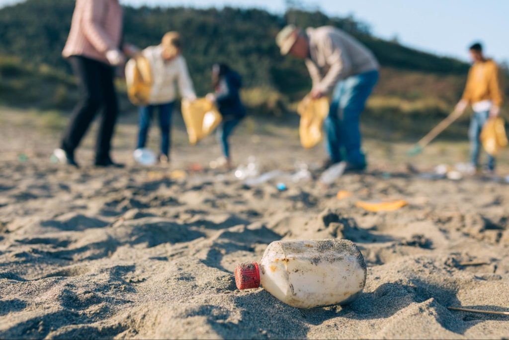 Group of volunteers picking up trash from a beach