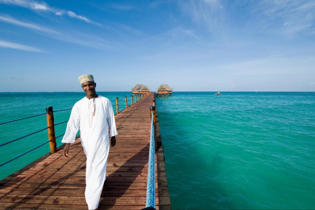 A worker in traditional dress at a hotel in Zanzibar on the ocean