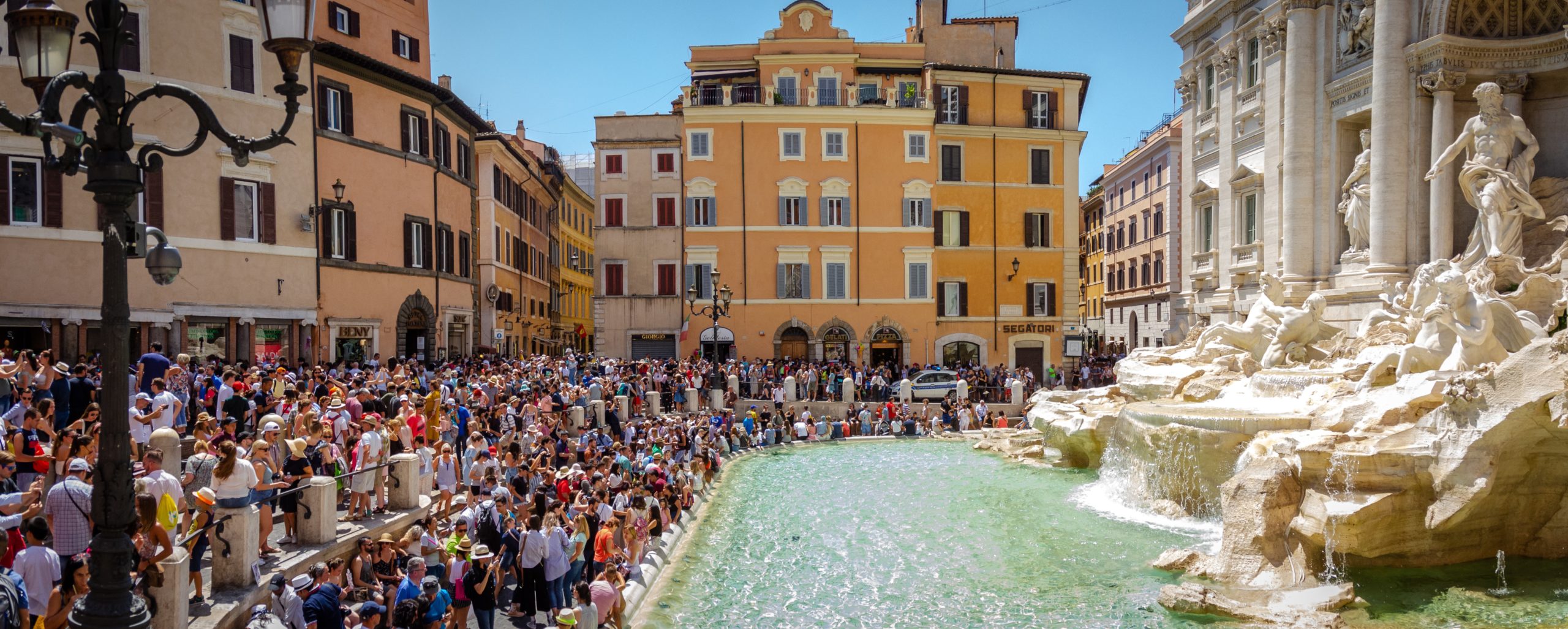 Shows overtourism at Trevi Fountain in Rome