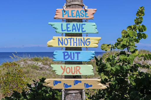 Sign depicting a common slogan directed towards tourists, encouraging them to be mindful of litter and leaving things behind. Emphasizes want for sustainable tourism by stakeholders (native people). it shows the importance of a DMO