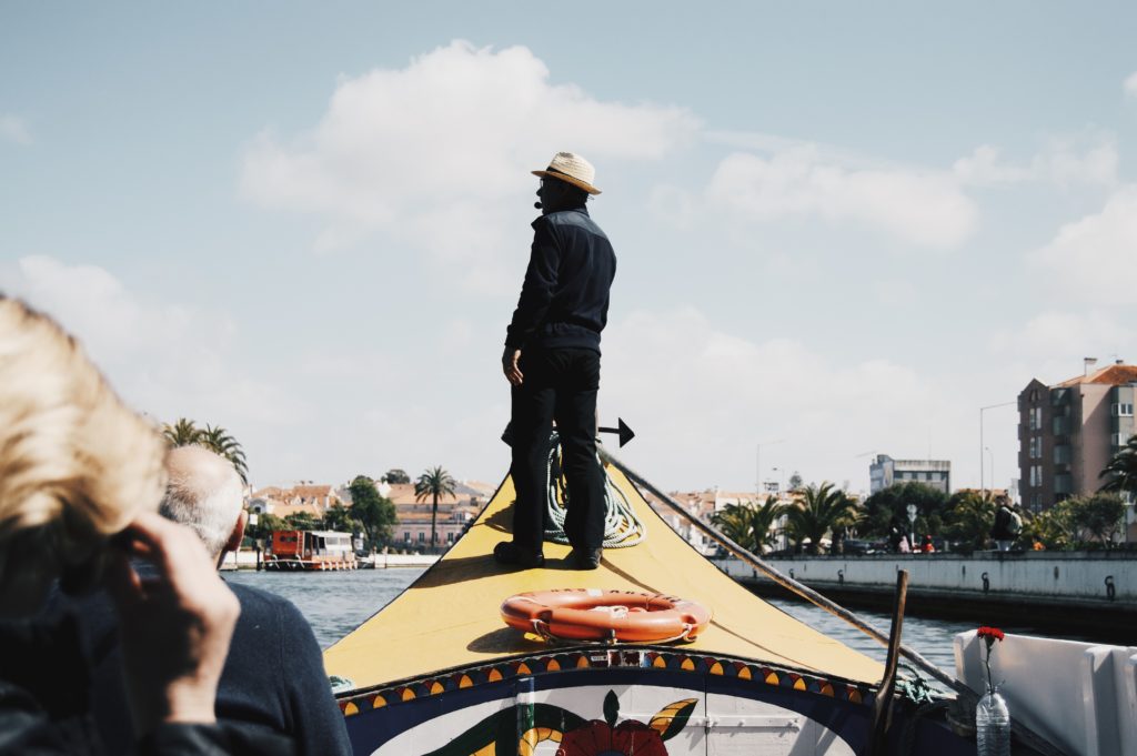 man commands river boat, connected to tourism industry